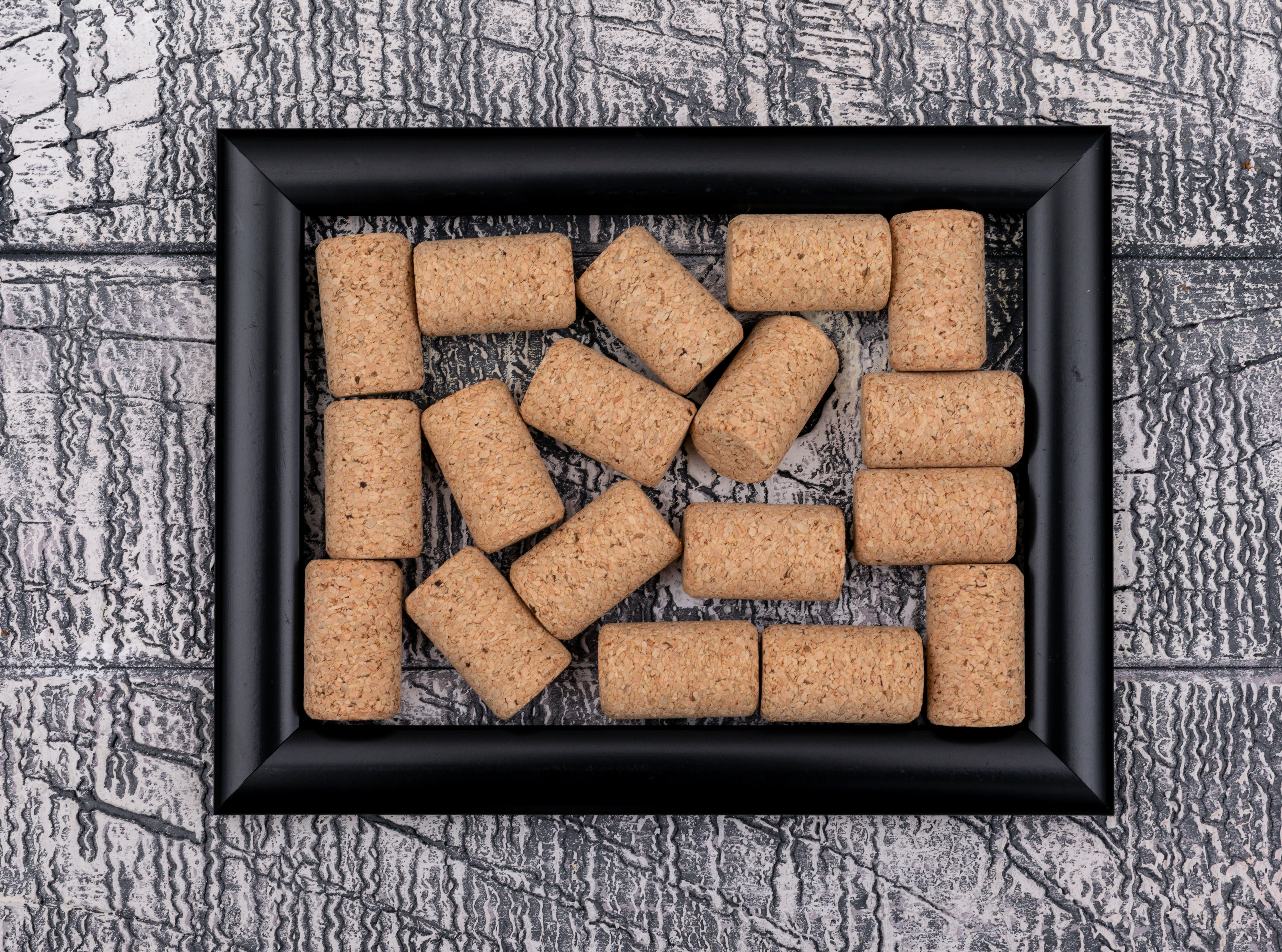 top view cork stoppers black frame white stone horizontal